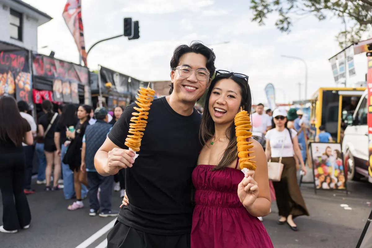 couple-holding-chips-on-a-stick-at-cabramatta-moon-festival-2025-photo-by-anna-kucera