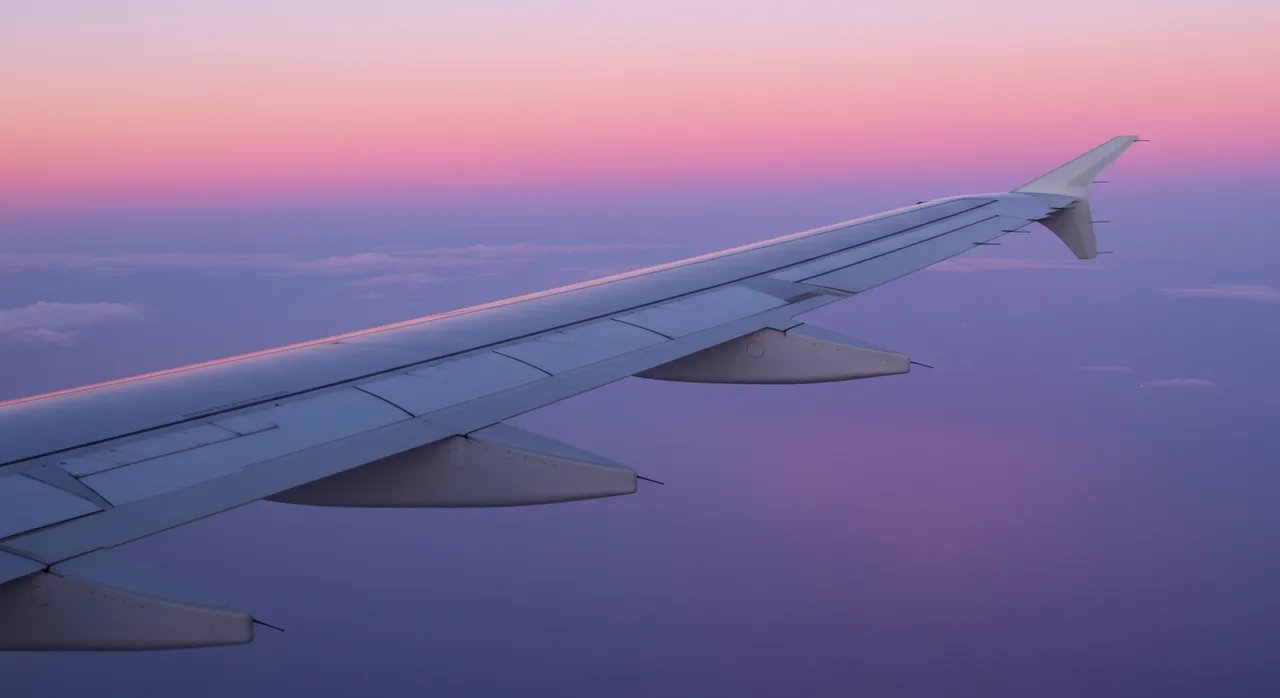 plane window with clouds
